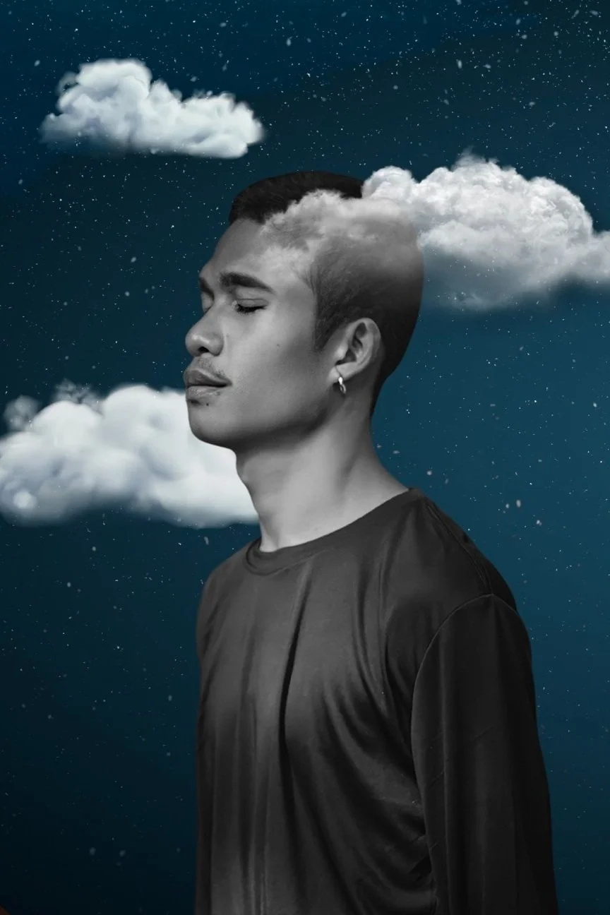 Portrait of a young man with soft clouds resting on his shoulders
